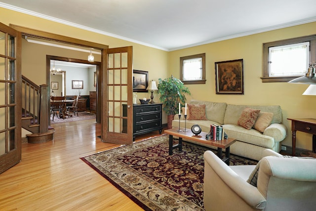 2454 Seneca Park Pl, Columbus, OH 43209 - living area featuring wood finished floors, plenty of natural light, a chandelier, and crown molding