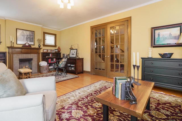 2454 Seneca Park Pl, Columbus, OH 43209 - living area featuring crown molding, wood finished floors, french doors, a fireplace, and baseboards