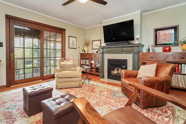2454 Seneca Park Pl, Columbus, OH 43209 - living room featuring ceiling fan, wood finished floors, crown molding, and a tiled fireplace