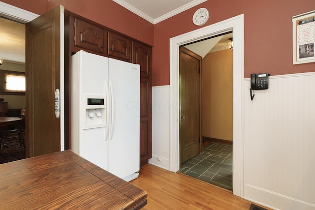 2454 Seneca Park Pl, Columbus, OH 43209 - kitchen with white refrigerator with ice dispenser, crown molding, a wainscoted wall, light wood-type flooring, and dark brown cabinetry
