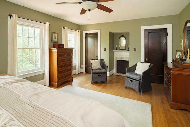 2454 Seneca Park Pl, Columbus, OH 43209 - bedroom featuring multiple windows, a fireplace, wood finished floors, and baseboards