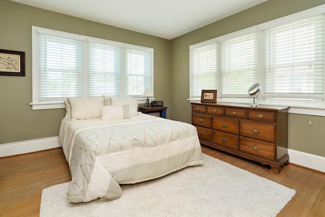 2454 Seneca Park Pl, Columbus, OH 43209 - bedroom featuring multiple windows, baseboards, and light wood-style floors