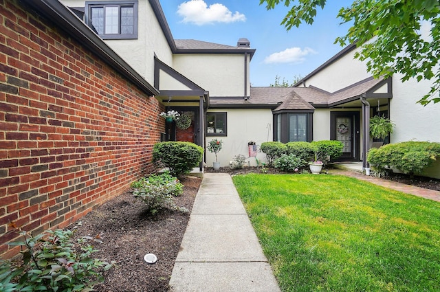 127 Saint Michelle St Unit 35B, Columbus, OH 43085 - entrance to property featuring stucco siding, a yard, and a shingled roof