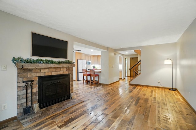 127 Saint Michelle St Unit 35B, Columbus, OH 43085 - living room featuring a brick fireplace, stairs, hardwood / wood-style floors, baseboards, and recessed lighting