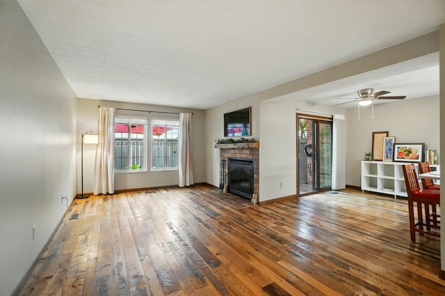 127 Saint Michelle St Unit 35B, Columbus, OH 43085 - unfurnished living room with wood-type flooring, a fireplace with flush hearth, baseboards, and ceiling fan