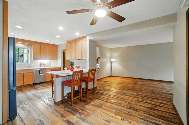 127 Saint Michelle St Unit 35B, Columbus, OH 43085 - kitchen featuring dishwasher, freestanding refrigerator, light countertops, hardwood / wood-style floors, and recessed lighting