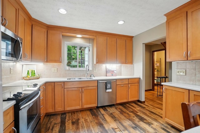 127 Saint Michelle St Unit 35B, Columbus, OH 43085 - kitchen featuring appliances with stainless steel finishes, a sink, dark wood-style floors, tasteful backsplash, and light countertops