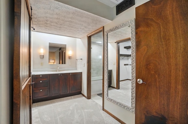 127 Saint Michelle St Unit 35B, Columbus, OH 43085 - bathroom with a textured ceiling, vanity, and baseboards