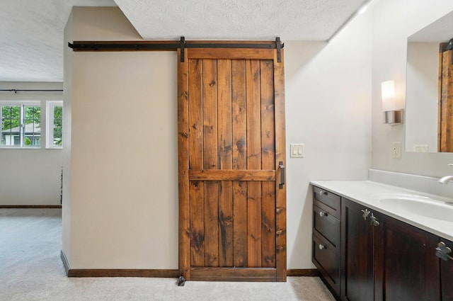 127 Saint Michelle St Unit 35B, Columbus, OH 43085 - bathroom featuring vanity, a textured ceiling, and baseboards
