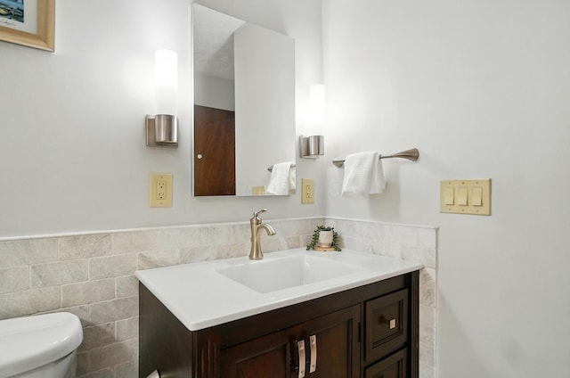 127 Saint Michelle St Unit 35B, Columbus, OH 43085 - bathroom with vanity, tile walls, toilet, and a wainscoted wall