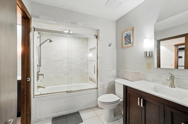 127 Saint Michelle St Unit 35B, Columbus, OH 43085 - bathroom with vanity, tile patterned flooring, toilet, and bath / shower combo with glass door
