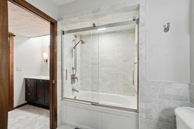 127 Saint Michelle St Unit 35B, Columbus, OH 43085 - full bath featuring bath / shower combo with glass door, vanity, toilet, and a textured ceiling