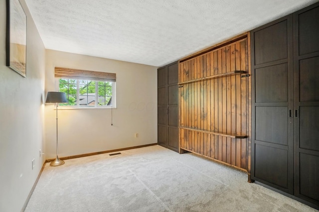 127 Saint Michelle St Unit 35B, Columbus, OH 43085 - unfurnished bedroom featuring light carpet, baseboards, and a textured ceiling