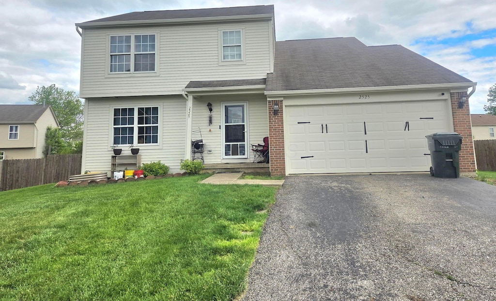 2525 Dexham Ct, Columbus, OH 43224 - view of front of home with asphalt driveway, an attached garage, and brick siding