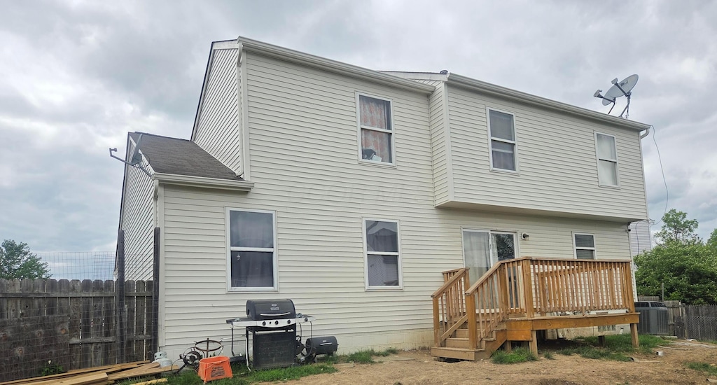 2525 Dexham Ct, Columbus, OH 43224 - rear view of property with fence, a deck, and central air condition unit