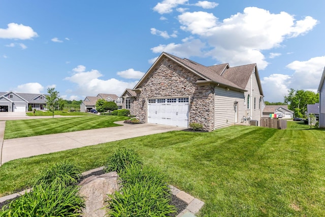 2036 Amber Wood Pl, Lancaster, OH 43130 - view of side of home with stone siding, concrete driveway, an attached garage, a yard, and a residential view
