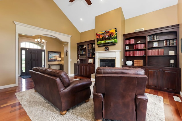 2036 Amber Wood Pl, Lancaster, OH 43130 - living room featuring a chandelier, ceiling fan, wood finished floors, a glass covered fireplace, and baseboards