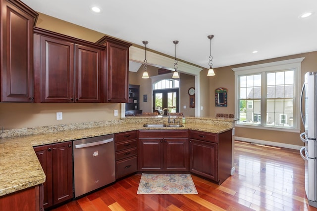 2036 Amber Wood Pl, Lancaster, OH 43130 - kitchen featuring stainless steel appliances, a sink, a peninsula, dark wood-type flooring, and dark brown cabinets