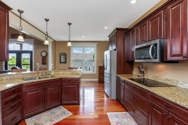 2036 Amber Wood Pl, Lancaster, OH 43130 - kitchen with stainless steel microwave, black electric stovetop, a sink, dark brown cabinets, and recessed lighting