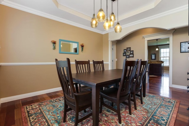 2036 Amber Wood Pl, Lancaster, OH 43130 - dining space featuring arched walkways, wood finished floors, baseboards, a raised ceiling, and ornamental molding