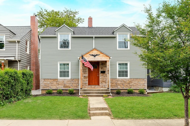 162 E Morrill Ave, Columbus, OH 43207 - view of front of property featuring stone siding, a front yard, a chimney, and roof with shingles