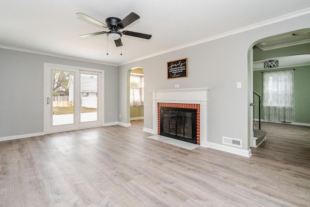 162 E Morrill Ave, Columbus, OH 43207 - unfurnished living room featuring arched walkways, crown molding, wood finished floors, baseboards, and a fireplace
