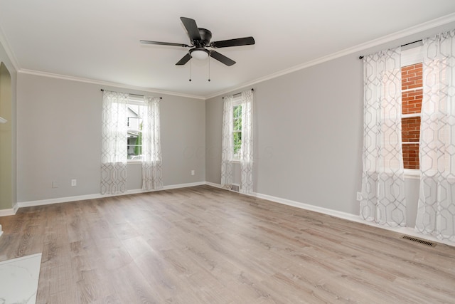 162 E Morrill Ave, Columbus, OH 43207 - spare room with ornamental molding, light wood-type flooring, a ceiling fan, baseboards, and arched walkways