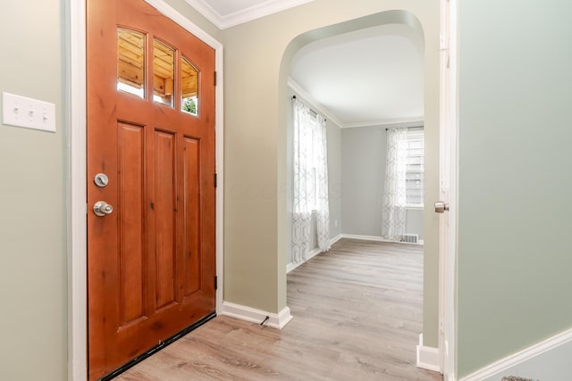 162 E Morrill Ave, Columbus, OH 43207 - foyer featuring crown molding, wood finished floors, baseboards, and arched walkways