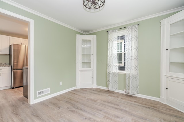 162 E Morrill Ave, Columbus, OH 43207 - unfurnished dining area with light wood-type flooring, ornamental molding, and baseboards