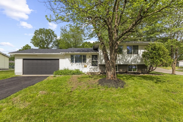 1530 Lexdale Dr, Reynoldsburg, OH 43068 - split level home featuring an attached garage, asphalt driveway, and a front yard