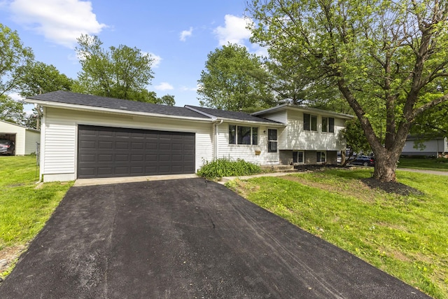 1530 Lexdale Dr, Reynoldsburg, OH 43068 - tri-level home with asphalt driveway, a garage, and a front yard