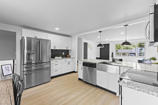 1530 Lexdale Dr, Reynoldsburg, OH 43068 - kitchen featuring stainless steel appliances, a sink, light wood-style flooring, white cabinets, and recessed lighting