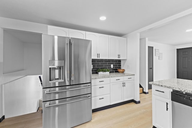 1530 Lexdale Dr, Reynoldsburg, OH 43068 - kitchen featuring stainless steel appliances, light wood-style floors, tasteful backsplash, white cabinets, and recessed lighting
