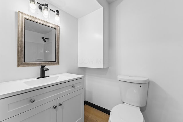 1530 Lexdale Dr, Reynoldsburg, OH 43068 - bathroom with toilet, vanity, wood finished floors, and baseboards