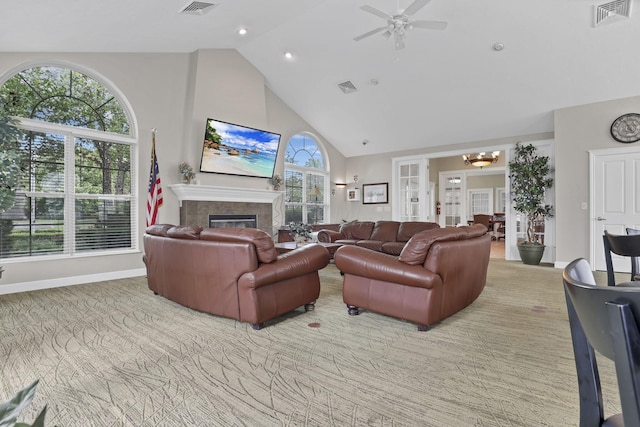 6542 Lakeview Cir, Canal Winchester, OH 43110 - carpeted living area featuring high vaulted ceiling, ceiling fan, a glass covered fireplace, a chandelier, and baseboards