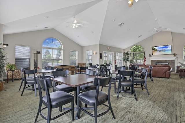 6542 Lakeview Cir, Canal Winchester, OH 43110 - dining area with a ceiling fan, light colored carpet, a fireplace, high vaulted ceiling, and plenty of natural light