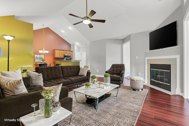 6542 Lakeview Cir, Canal Winchester, OH 43110 - living area featuring dark wood-type flooring, a ceiling fan, high vaulted ceiling, a chandelier, and a tiled fireplace