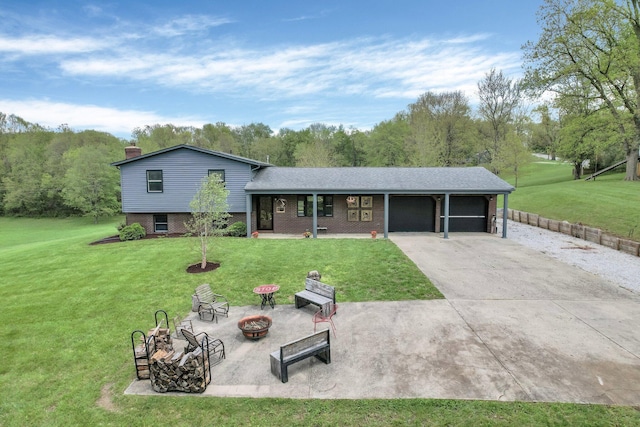 699 Cedar Run Rd NE, Newark, OH 43055 - split level home with a fire pit, a garage, a front lawn, and brick siding
