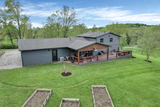 699 Cedar Run Rd NE, Newark, OH 43055 - rear view of property with a lawn, a vegetable garden, a wooden deck, and a shingled roof