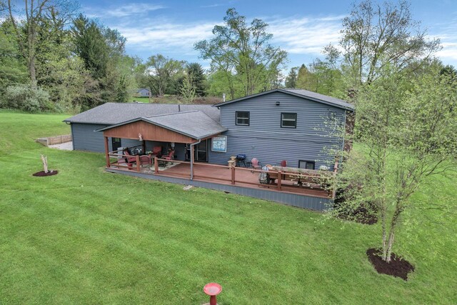 699 Cedar Run Rd NE, Newark, OH 43055 - back of house with a deck, a lawn, and view of scattered trees