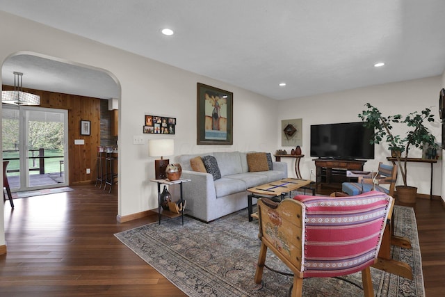 699 Cedar Run Rd NE, Newark, OH 43055 - living room with arched walkways, wooden walls, baseboards, wood finished floors, and recessed lighting