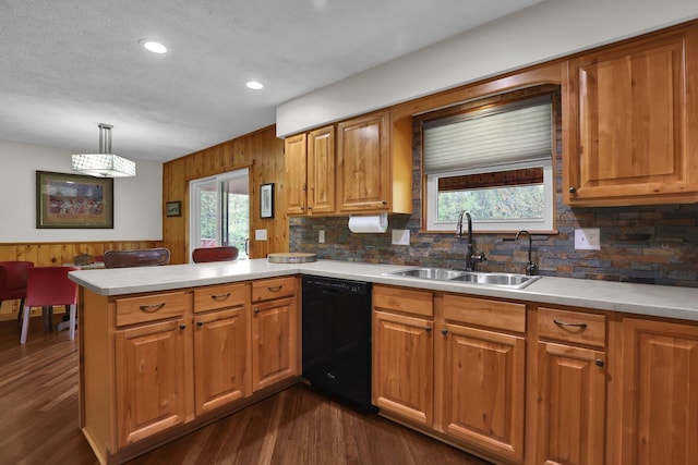 699 Cedar Run Rd NE, Newark, OH 43055 - kitchen featuring dishwasher, a sink, a peninsula, light countertops, and wooden walls