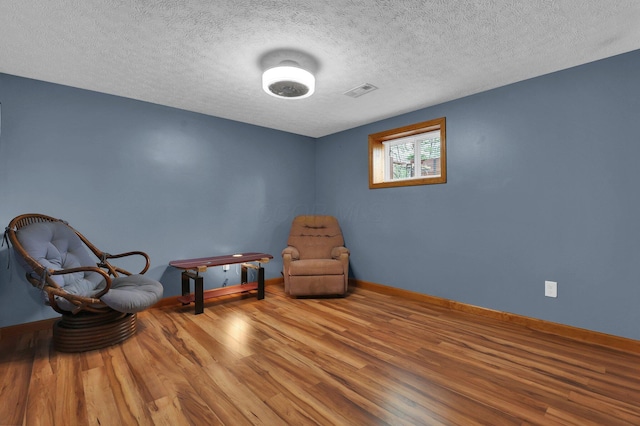 699 Cedar Run Rd NE, Newark, OH 43055 - sitting room with wood finished floors, baseboards, and a textured ceiling