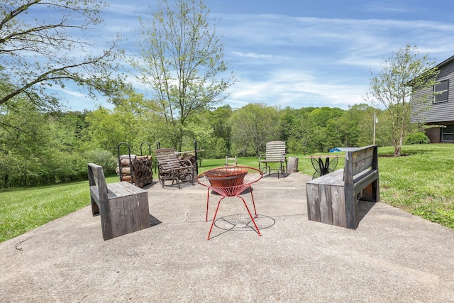 699 Cedar Run Rd NE, Newark, OH 43055 - view of patio with a fire pit and a forest view