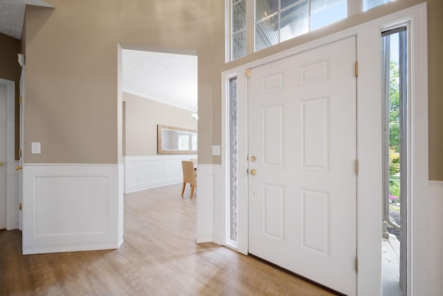 272 Trail E, Etna, OH 43062 - foyer entrance with plenty of natural light, a wainscoted wall, light wood-style floors, ornamental molding, and a decorative wall