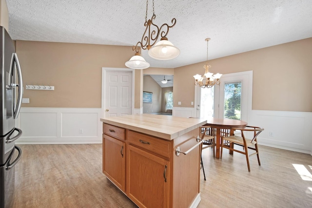 272 Trail E, Etna, OH 43062 - kitchen with freestanding refrigerator, butcher block counters, light wood finished floors, a wainscoted wall, and a chandelier