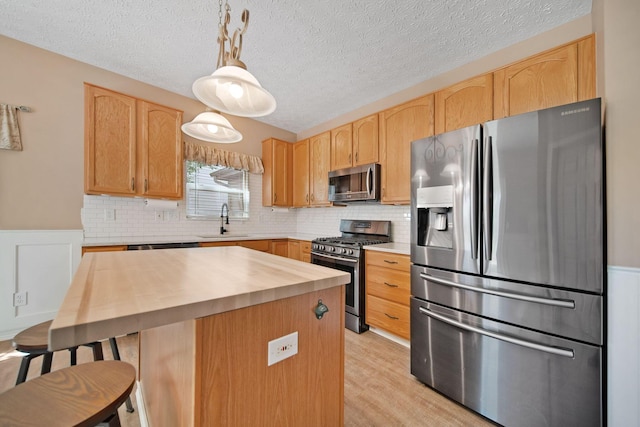 272 Trail E, Etna, OH 43062 - kitchen featuring stainless steel appliances, a sink, butcher block countertops, light brown cabinets, and tasteful backsplash