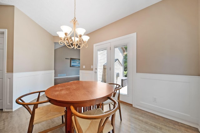 272 Trail E, Etna, OH 43062 - dining space with a wainscoted wall, light wood-style floors, a chandelier, and a decorative wall