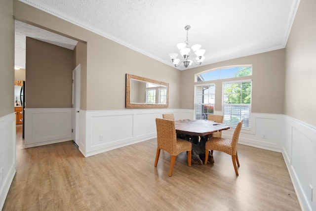 272 Trail E, Etna, OH 43062 - dining area with a chandelier, light wood-style flooring, ornamental molding, wainscoting, and a decorative wall