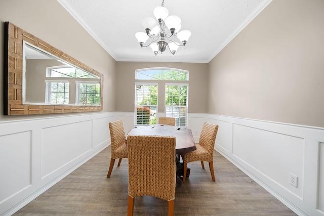 272 Trail E, Etna, OH 43062 - dining area featuring a chandelier, crown molding, light wood-style flooring, a decorative wall, and a wainscoted wall